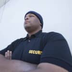 Professional security guard in uniform standing vigilantly outdoors in Vancouver.