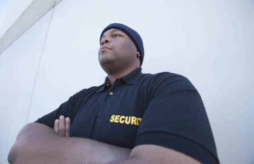Professional security guard in uniform standing vigilantly outdoors in Vancouver.