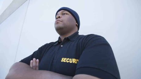 Professional security guard in uniform standing vigilantly outdoors in Vancouver.