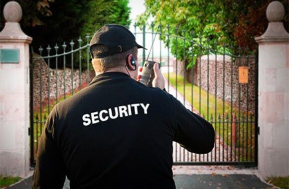 Residential security guard monitoring a gated property in Vancouver with a two-way radio.