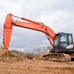 Excavator at a construction site in Vancouver secured by BestWORLD's professional security services.