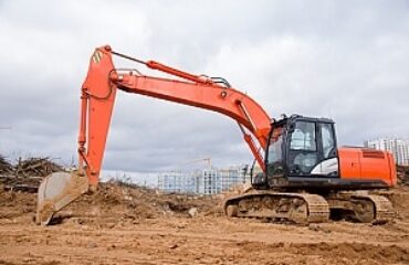 Excavator at a construction site in Vancouver secured by BestWORLD's professional security services.