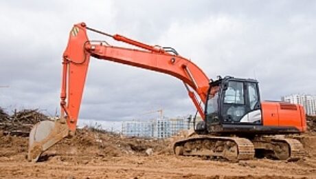 Excavator at a construction site in Vancouver secured by BestWORLD's professional security services.